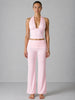 Woman wearing a pink outfit against a gray background