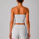 Woman wearing a gray strapless top and shorts set on a plain background