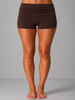 Brown shorts worn by a person on a gray background
