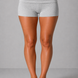 Person wearing gray shorts on a plain background