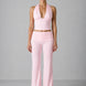 Woman wearing a pink outfit against a gray background