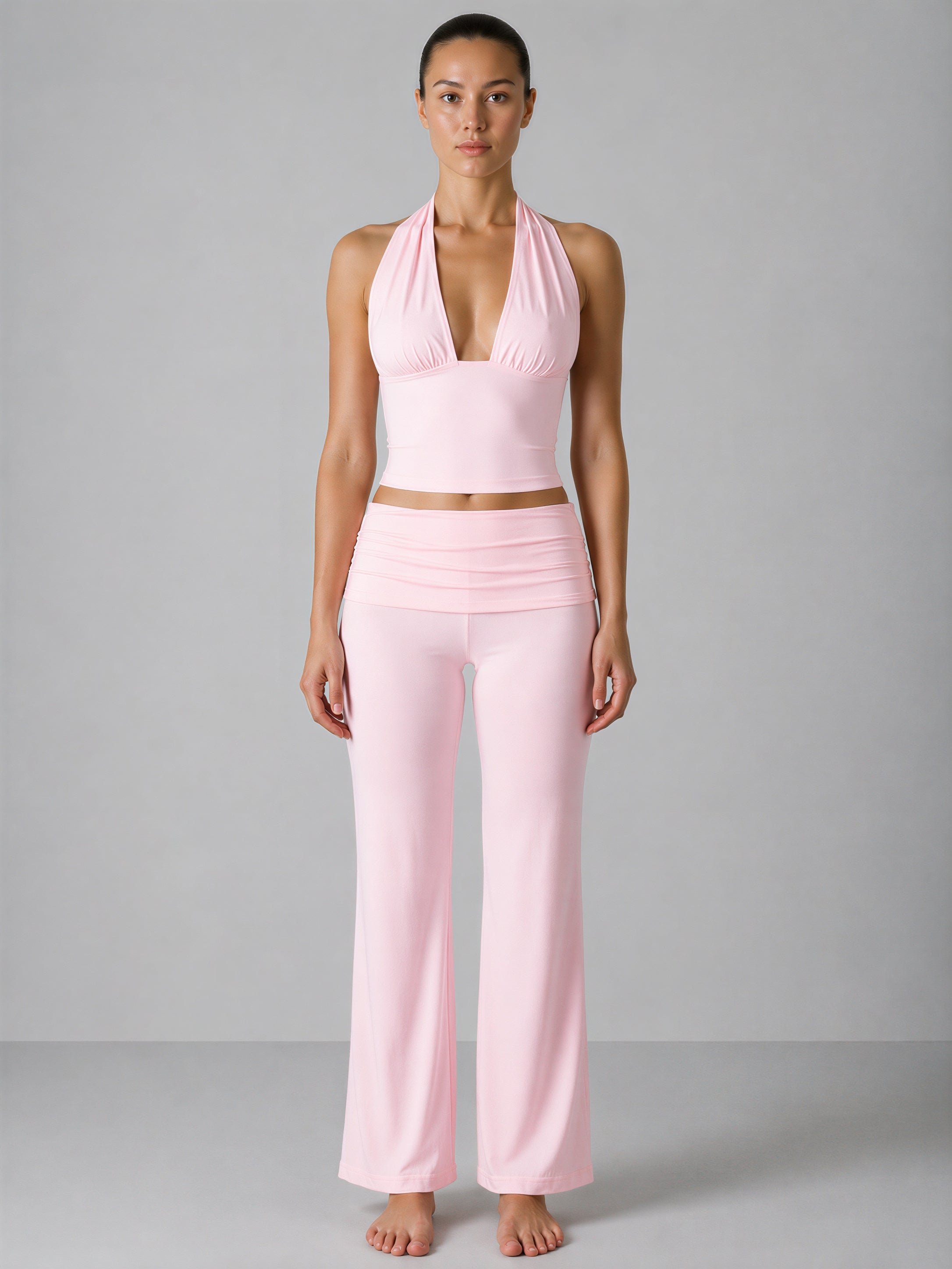 Woman wearing a pink outfit against a gray background