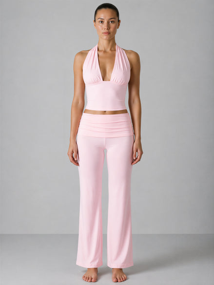 Woman wearing a pink outfit against a gray background