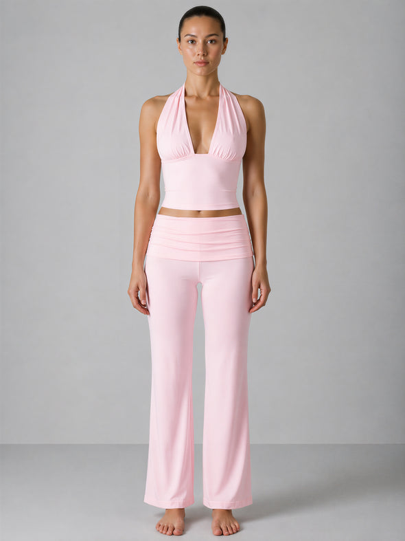 Woman wearing a pink outfit against a gray background
