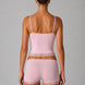 Woman wearing a pink lingerie set with lace details on a gray background