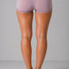 Person wearing light purple Shorts with lace trim on a gray background