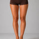 Brown lace-trimmed shorts worn by a person on a gray background
