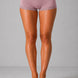 Person wearing purple lace-trimmed shorts on a gray background